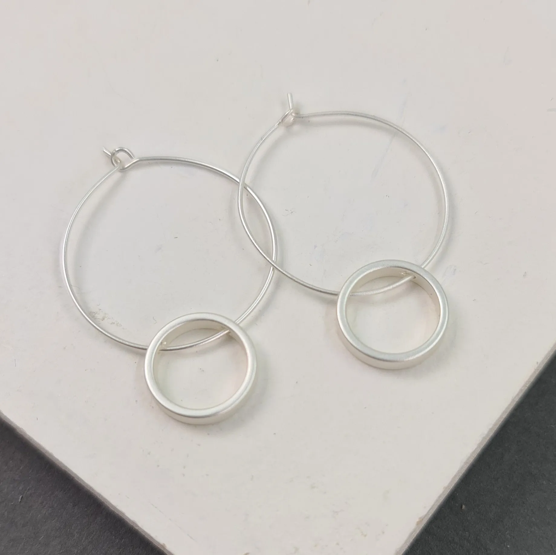 Fine hoop earrings with circle component